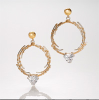 dangling silver hoop earrings with gold wrapped wire.